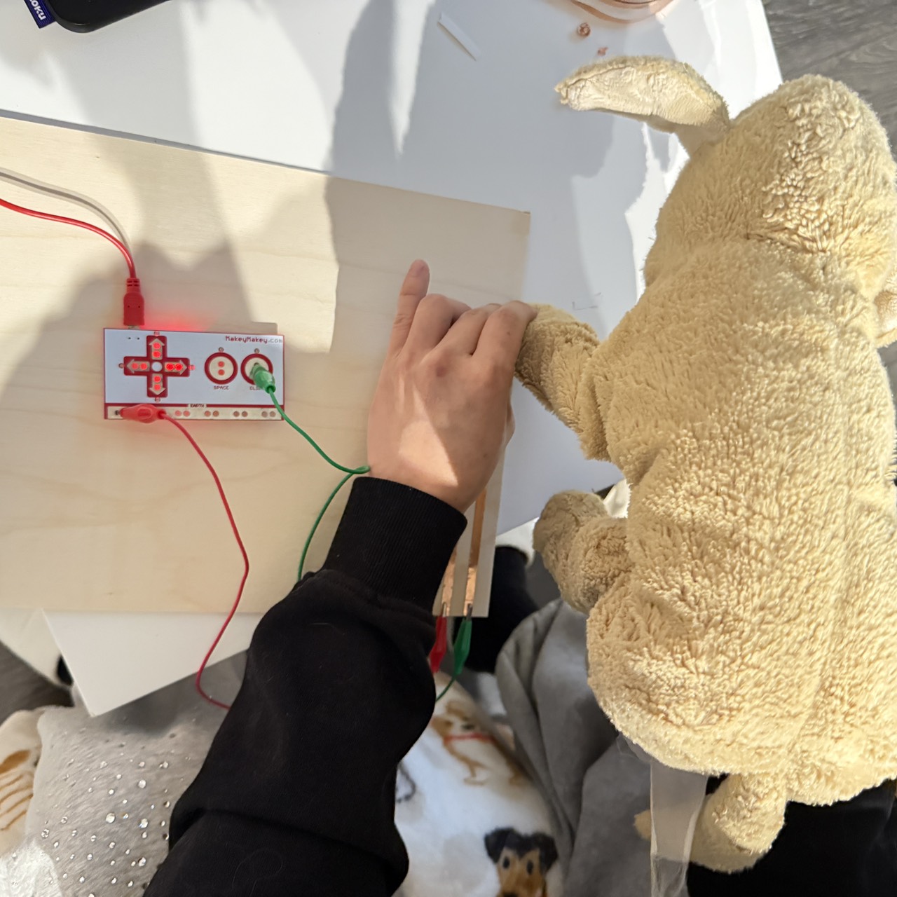 The early prototype reveals that placing the paw pads in four corners feels natural for a dog’s movement. The UX unknown is whether users will understand which pad triggers which action without additional visual cues.