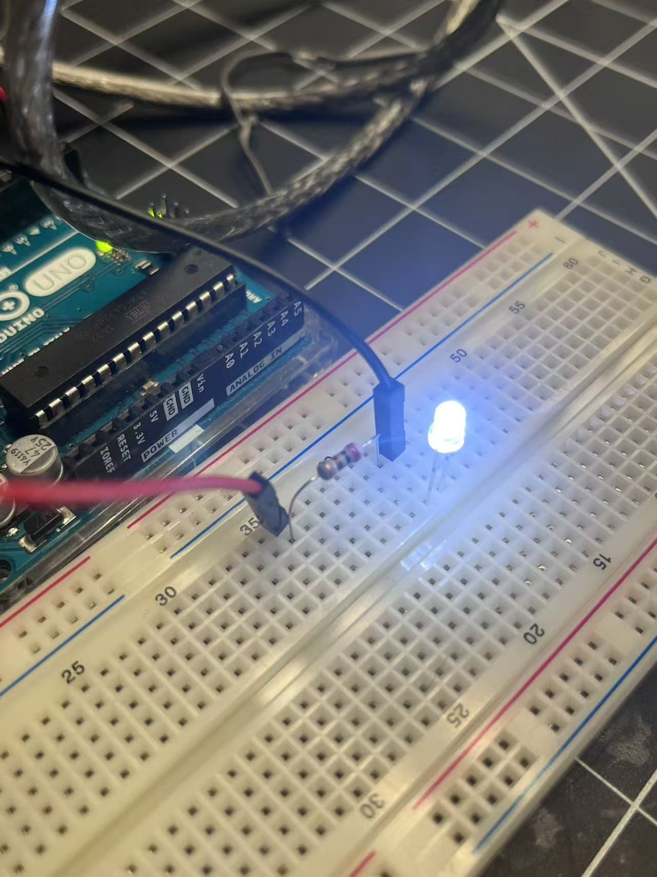 A close-up of the LED and resistor setup on the breadboard, showing proper wiring and current control for stable brightness.